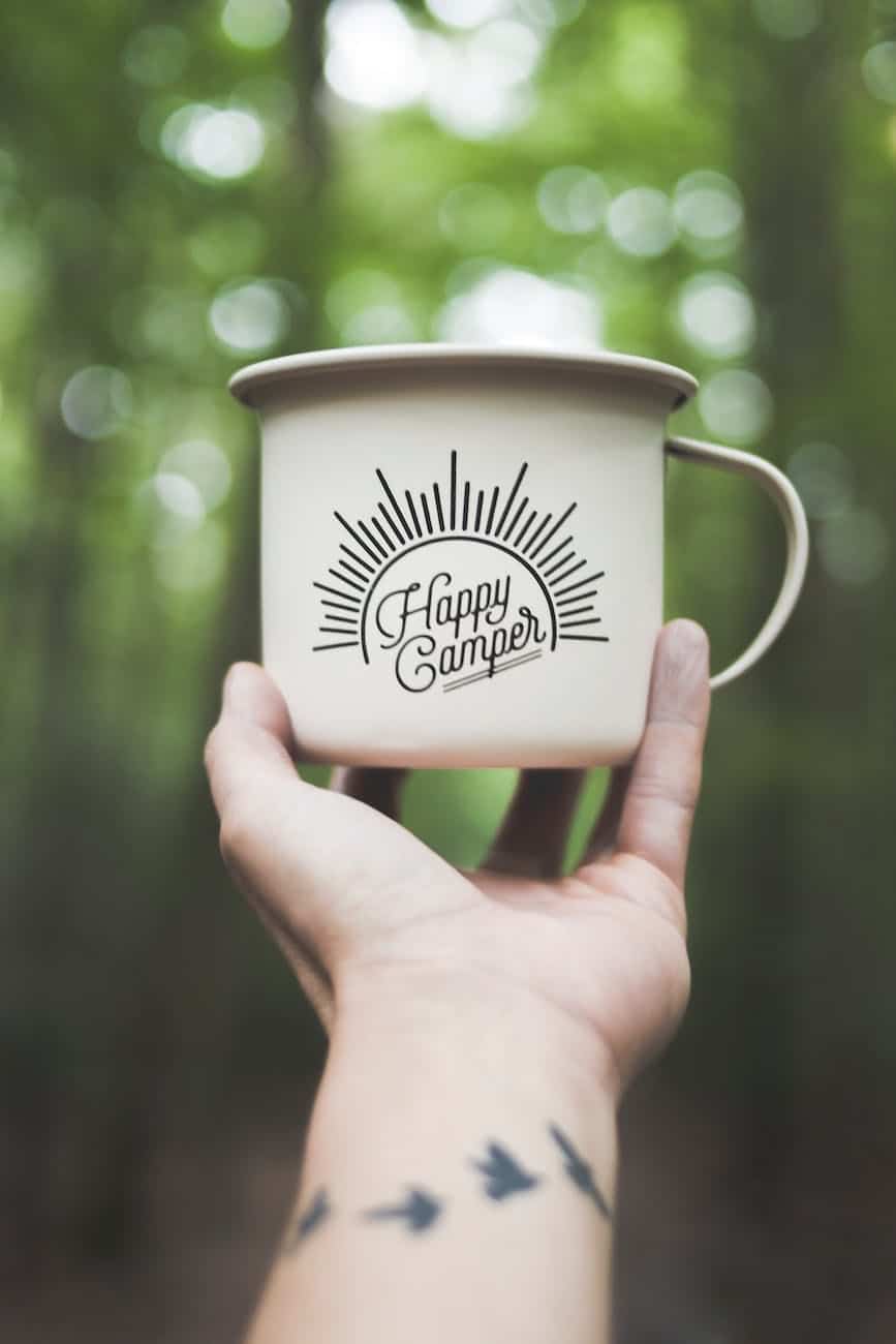 person holding white ceramic mug